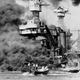 Survivors are rescued from the waters of Pearl Harbor as USS West Virginia burns in the background. (US Navy)